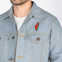Load image into Gallery viewer, Palestine Watermelon label Pin on a light blue jean jacket worn by a male model. Sold by the Classy Vendor.
